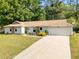 Charming single-story home with stone accents, attached garage, and well-manicured lawn at 2014 Anchor Way, Buford, GA 30518