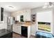Functional kitchen featuring stainless steel appliances, white cabinets, and a sink with a view at 2014 Anchor Way, Buford, GA 30518