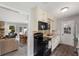 Well-lit kitchen features wood floors, black appliances and bright countertops with a view of the dining and living rooms at 2014 Anchor Way, Buford, GA 30518