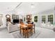 Spacious living area with a stone fireplace, dining set, and French doors leading to outdoor at 2014 Anchor Way, Buford, GA 30518