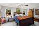 Well-lit main bedroom with a large bed between two windows, dressers, and neutral wall color at 2014 Anchor Way, Buford, GA 30518