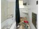 Small bathroom featuring a bathtub, sink, and a curtain; showing signs of disrepair and needing renovation at 3090 Sunset Se Rd, Conyers, GA 30094