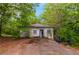 Exterior shot of a small, rundown single-story house with a visible yard needing maintenance at 3090 Sunset Se Rd, Conyers, GA 30094