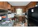 A messy kitchen with outdated appliances and cabinetry, requiring thorough cleaning and remodeling at 3090 Sunset Se Rd, Conyers, GA 30094