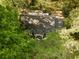 Aerial view of a shingled roof home surrounded by lush, mature trees at 400 Collier Rd, Atlanta, GA 30309