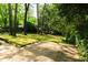Picturesque backyard features manicured lawn and mature trees, perfect for outdoor enjoyment at 400 Collier Rd, Atlanta, GA 30309