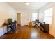 Spacious room featuring hardwood floors, computer, and musical instruments at 400 Collier Rd, Atlanta, GA 30309