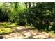 Long driveway surrounded by mature trees and manicured landscaping at 400 Collier Rd, Atlanta, GA 30309