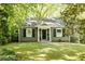 Charming one-story home with beautiful landscaping and a well-manicured lawn at 400 Collier Rd, Atlanta, GA 30309