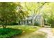Quaint home with gray siding, manicured lawn, and mature trees at 400 Collier Rd, Atlanta, GA 30309