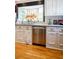 Kitchen features white cabinets, granite counters, stainless steel appliances, and bay window above the sink at 400 Collier Rd, Atlanta, GA 30309