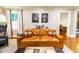 Comfortable living room with a plush leather sofa, elegant artwork, and natural light at 400 Collier Rd, Atlanta, GA 30309