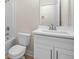Clean bathroom featuring a white vanity, toilet, and tub with modern fixtures at 5443 Blossomwood Sw Trl, Mableton, GA 30126
