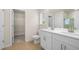 Bathroom featuring double sinks, wood flooring, and a doorway to a walk in closet at 5443 Blossomwood Sw Trl, Mableton, GA 30126