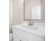 Modern bathroom with white vanity, sleek mirror, and neutral tones, offering a serene atmosphere at 5443 Blossomwood Sw Trl, Mableton, GA 30126