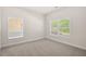 Bright bedroom featuring neutral carpet, trim, and natural light from two large windows at 5443 Blossomwood Sw Trl, Mableton, GA 30126
