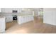 Open kitchen with white cabinets, a center island, and stainless steel appliances, creating a modern living space at 5443 Blossomwood Sw Trl, Mableton, GA 30126