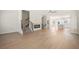 Open concept living room with hardwood floors, a modern fireplace, and staircase at 5443 Blossomwood Sw Trl, Mableton, GA 30126