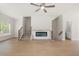 Neutral living room featuring hardwood floors, a modern fireplace, and a staircase at 5443 Blossomwood Sw Trl, Mableton, GA 30126