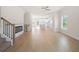 Open-concept living room featuring hardwood floors, fireplace, and view into kitchen at 5443 Blossomwood Sw Trl, Mableton, GA 30126