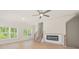 Bright living room with modern fireplace, hardwood floors, and ceiling fan at 5443 Blossomwood Sw Trl, Mableton, GA 30126