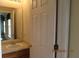 A bathroom featuring a vanity with brushed nickel fixtures, mirror, and neutral colors at 7238 April Ct, Morrow, GA 30260