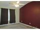 Bedroom featuring neutral carpeting, ceiling fan, and window with curtains at 7238 April Ct, Morrow, GA 30260