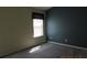 A cozy bedroom features a window, two-tone walls, and neutral carpet flooring at 7238 April Ct, Morrow, GA 30260