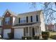 Inviting two-story home boasts an attached garage, brick accents, and well-manicured landscaping at 7238 April Ct, Morrow, GA 30260