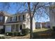A two-story townhouse featuring a garage, covered porch, and manicured lawn at 7238 April Ct, Morrow, GA 30260