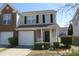 Two-story home with attached garage and well-maintained lawn at 7238 April Ct, Morrow, GA 30260