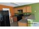 Kitchen featuring wood cabinets and black appliances at 7238 April Ct, Morrow, GA 30260