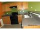 Kitchen featuring wood cabinets and black appliances at 7238 April Ct, Morrow, GA 30260