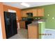Kitchen featuring wood cabinets, black appliances, and a bar at 7238 April Ct, Morrow, GA 30260