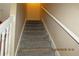 Carpeted stairway with white railing leads to the upper level of the home at 7238 April Ct, Morrow, GA 30260