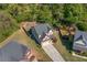 Aerial view of a charming home featuring a fenced backyard and an extended driveway at 100 Cottage Nw Walk, Cartersville, GA 30121
