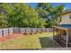 Well-maintained backyard with a privacy fence, grassy lawn, and access to a screened porch at 100 Cottage Nw Walk, Cartersville, GA 30121
