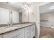 Bathroom featuring double sinks, granite counters, and a mirror, with a bedroom in view at 100 Cottage Nw Walk, Cartersville, GA 30121