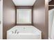 Spacious bathtub is complemented by a large window and a separate shower at 100 Cottage Nw Walk, Cartersville, GA 30121