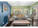 Charming dining room with a rustic-style table, bench seating, hardwood floors, and bright lighting at 100 Cottage Nw Walk, Cartersville, GA 30121