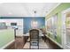Charming dining room features dark wood floors, blue accent wall, and seating for six at 100 Cottage Nw Walk, Cartersville, GA 30121