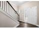 Elegant foyer with hardwood floors, a staircase with black iron railing, and a bright white front door at 100 Cottage Nw Walk, Cartersville, GA 30121