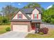 Charming two-story home with a stone accent garage, red shutters, and a landscaped front yard at 100 Cottage Nw Walk, Cartersville, GA 30121