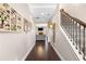 Bright hallway with hardwood floors, staircase, and a glimpse into the living room at 100 Cottage Nw Walk, Cartersville, GA 30121