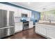 Stylish kitchen featuring white cabinets, stainless steel appliances, granite countertops, and hardwood floors at 100 Cottage Nw Walk, Cartersville, GA 30121