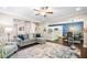 Living room showcasing hardwood floors, a comfortable sofa, and an open layout with access to the kitchen and dining areas at 100 Cottage Nw Walk, Cartersville, GA 30121