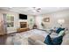 Living room showcasing a stone fireplace, ceiling fan, hardwood floors, and comfortable seating at 100 Cottage Nw Walk, Cartersville, GA 30121