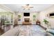 Bright living room with stone fireplace, ceiling fan, hardwood floors, and a large area rug at 100 Cottage Nw Walk, Cartersville, GA 30121