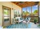 Inviting screened porch with comfortable seating, a ceiling fan, and outdoor views at 100 Cottage Nw Walk, Cartersville, GA 30121