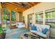 Cozy screened porch featuring ample seating, decor, and access to the outdoors at 100 Cottage Nw Walk, Cartersville, GA 30121